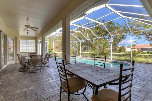 view of patio featuring glass enclosure and ceiling fan