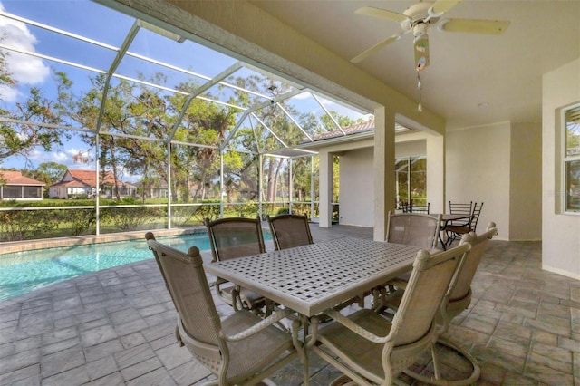 view of patio / terrace with ceiling fan and a lanai