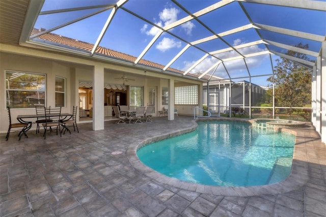 view of swimming pool featuring ceiling fan, a lanai, a patio, and an in ground hot tub