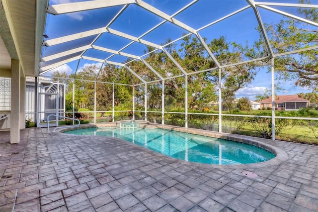 view of pool featuring an in ground hot tub, glass enclosure, and a patio area