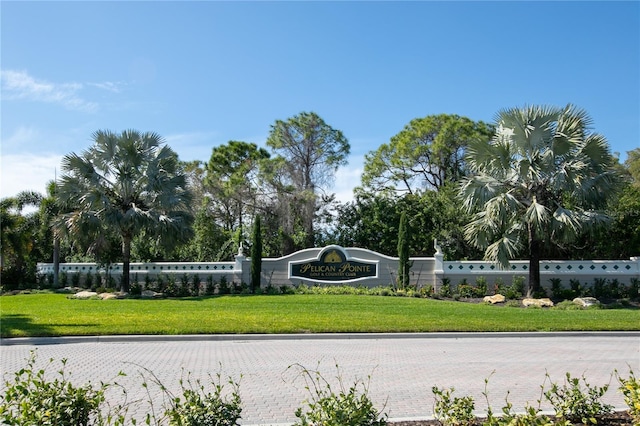 community sign featuring a lawn