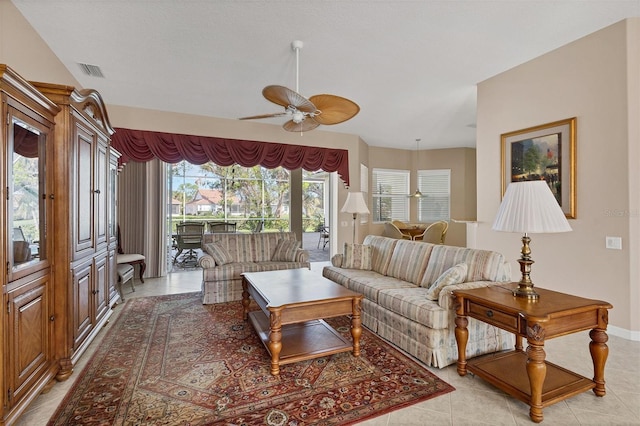 tiled living room featuring plenty of natural light and ceiling fan