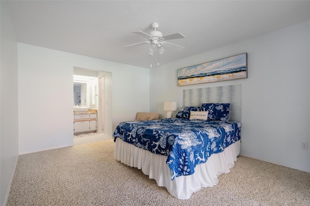 carpeted bedroom with ensuite bath and ceiling fan