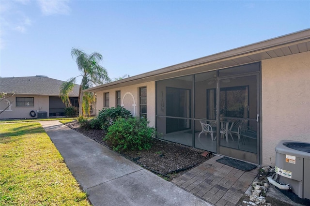 exterior space featuring a yard and central air condition unit