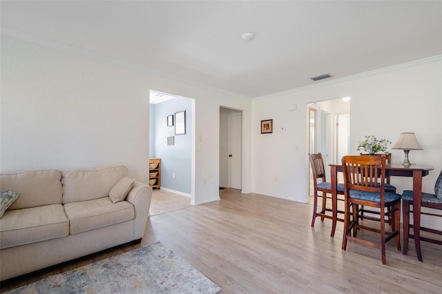 living room featuring crown molding and light wood-type flooring