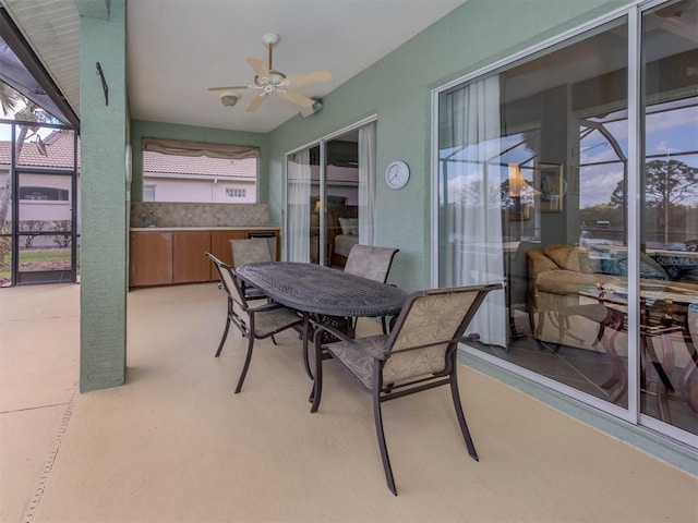 sunroom / solarium featuring ceiling fan