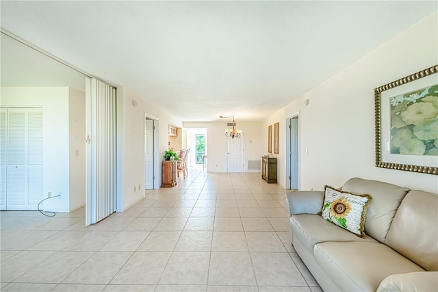 unfurnished living room with light tile patterned flooring and an inviting chandelier