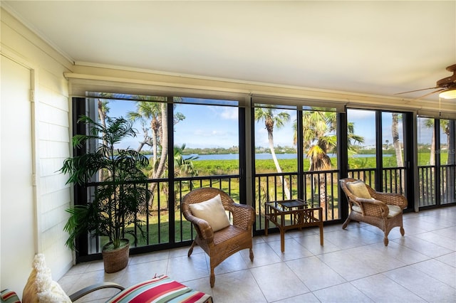 sunroom featuring a water view, a wealth of natural light, and ceiling fan