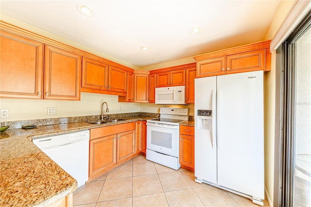 kitchen featuring light stone counters, white appliances, sink, and light tile patterned floors