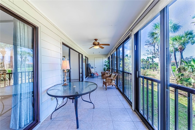 sunroom / solarium with plenty of natural light and ceiling fan