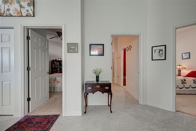 corridor featuring light colored carpet