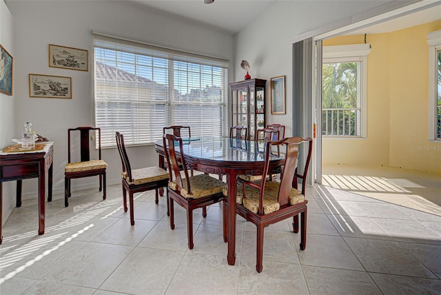 dining space featuring light tile patterned flooring