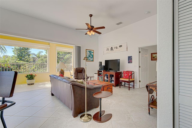 living room featuring ceiling fan and light tile patterned floors