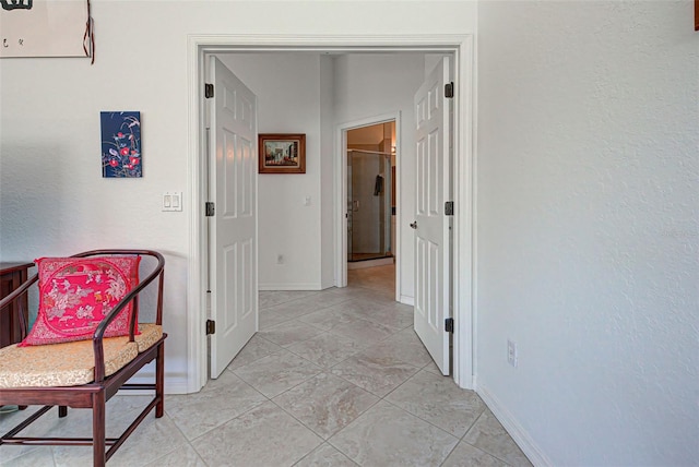 hallway featuring light tile patterned flooring