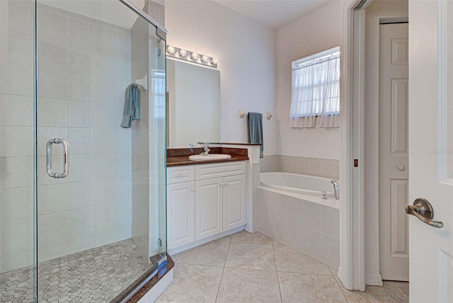 bathroom with vanity, tile patterned floors, and shower with separate bathtub