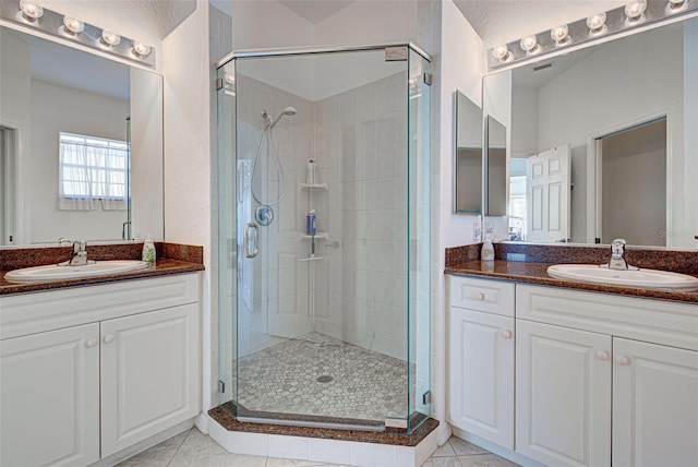 bathroom with vanity, tile patterned flooring, and an enclosed shower