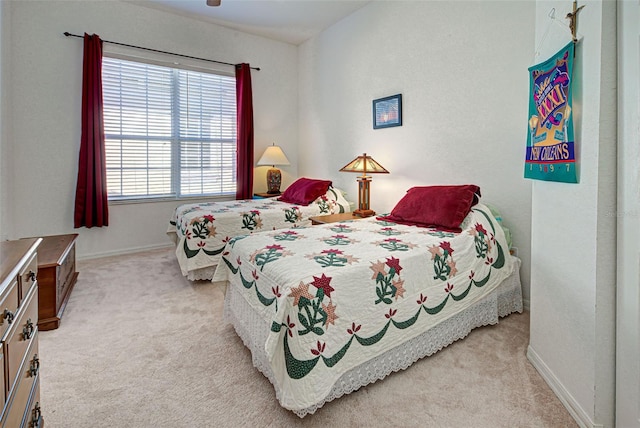 bedroom featuring light carpet