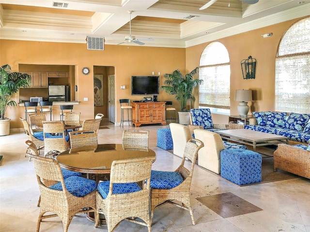 dining space with a wealth of natural light, coffered ceiling, beam ceiling, and ceiling fan