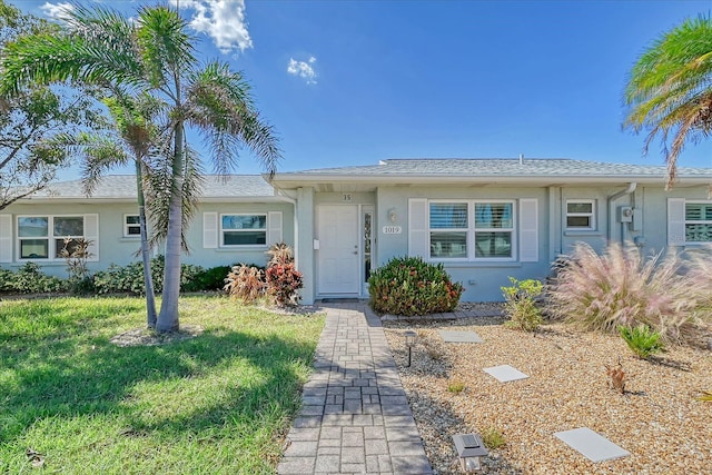 ranch-style home with a front lawn