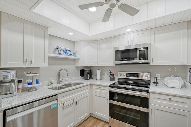 kitchen featuring sink, white cabinetry, and stainless steel appliances