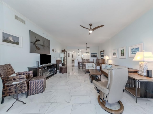 living room with crown molding and ceiling fan with notable chandelier