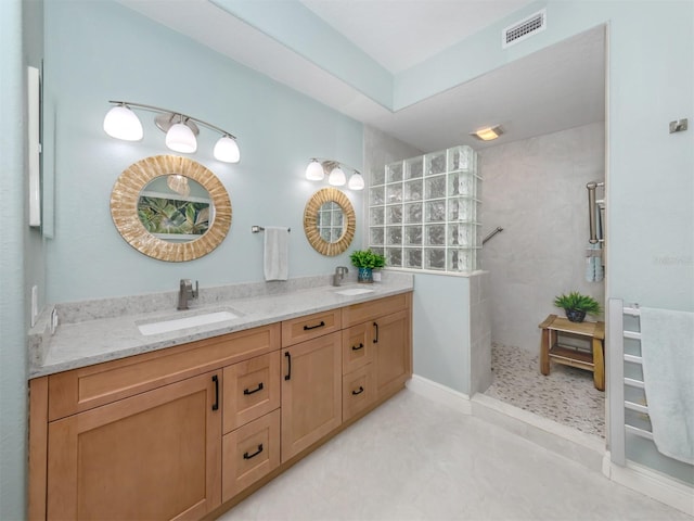 bathroom with vanity and a shower