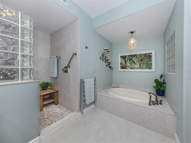 147 Tampa Ave E Unit 202, Venice, FL 34285 - full bath featuring a garden tub, a walk in shower, and tile patterned floors