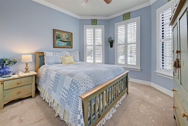 carpeted bedroom with ceiling fan and crown molding