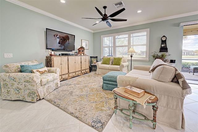 living room featuring ornamental molding, ceiling fan, light tile patterned floors, and a healthy amount of sunlight