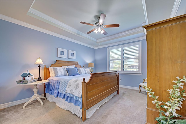 bedroom with ceiling fan, light carpet, a raised ceiling, and ornamental molding