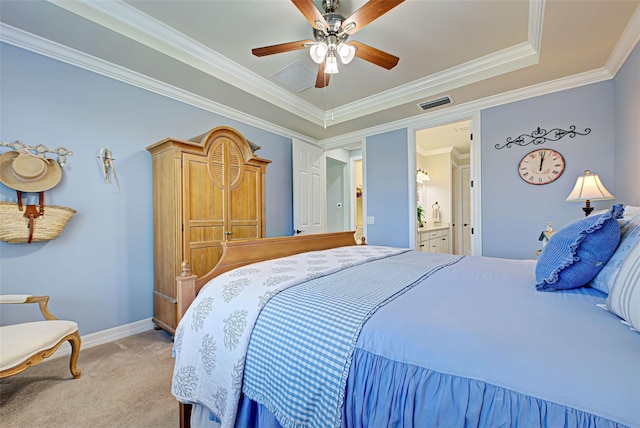 carpeted bedroom featuring ensuite bathroom, ceiling fan, a raised ceiling, and crown molding