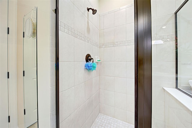 bathroom featuring a shower with door