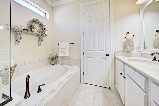 bathroom with tiled bath, vanity, and ornamental molding