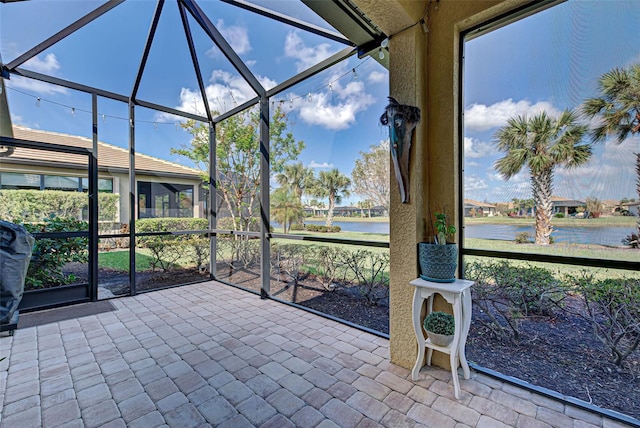 unfurnished sunroom with a water view