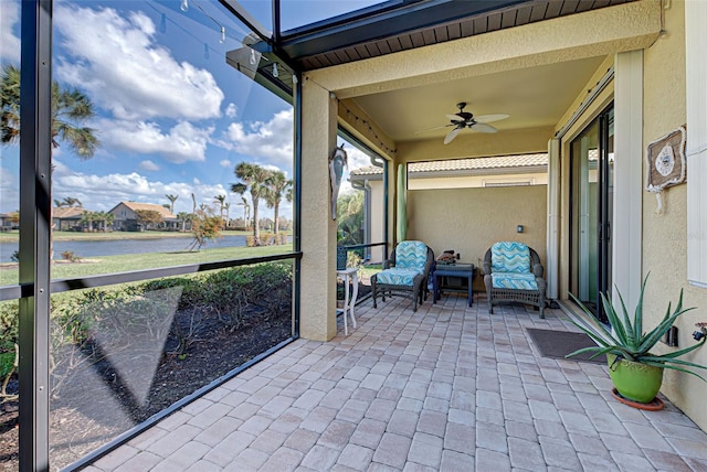 unfurnished sunroom featuring ceiling fan