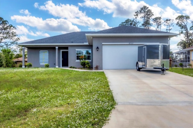 view of front of property featuring a garage and a front lawn