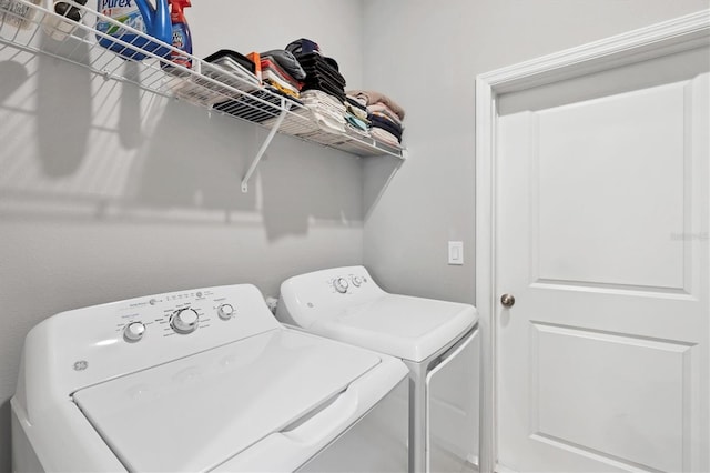 washroom featuring washing machine and clothes dryer