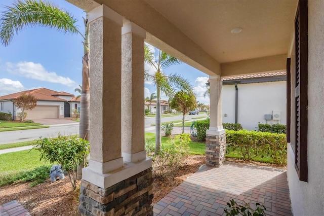 view of patio featuring covered porch and a garage