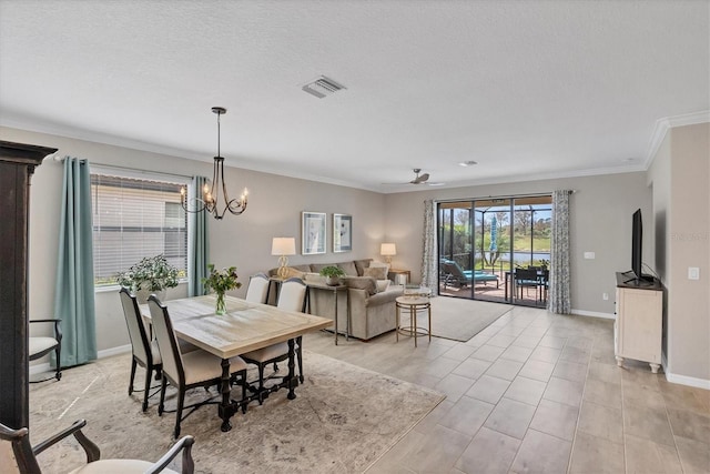 dining space featuring a textured ceiling, ornamental molding, and ceiling fan with notable chandelier