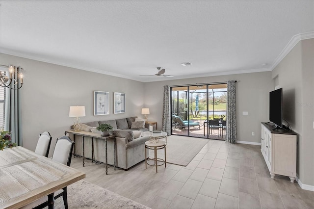 living room featuring ornamental molding and ceiling fan with notable chandelier