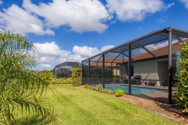 view of pool with a yard and glass enclosure