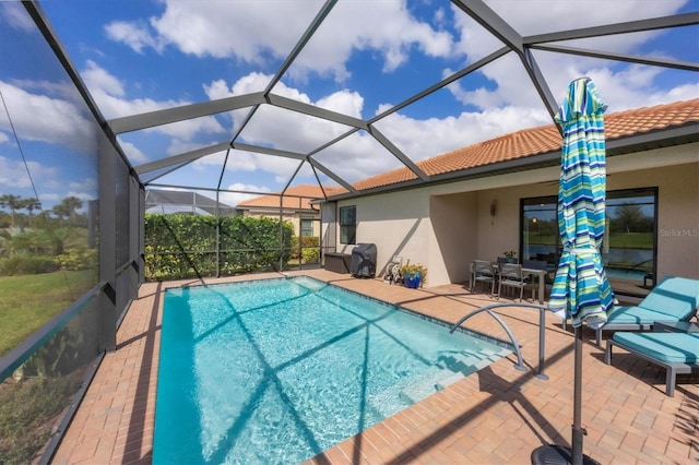 view of pool with a lanai and a patio area