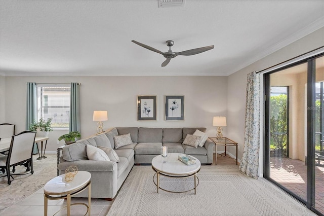 living room featuring ceiling fan and crown molding