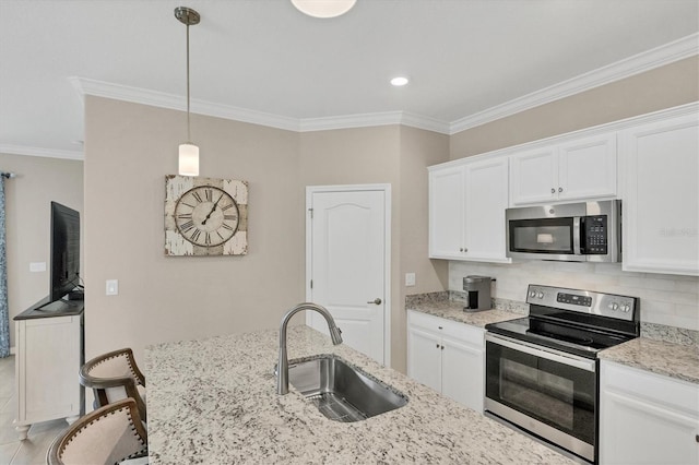 kitchen with stainless steel appliances, decorative light fixtures, white cabinets, light stone counters, and sink