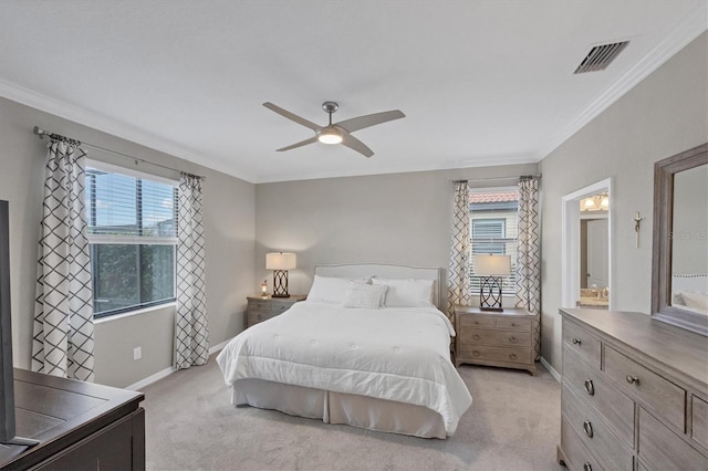 bedroom featuring ceiling fan, multiple windows, crown molding, and light carpet