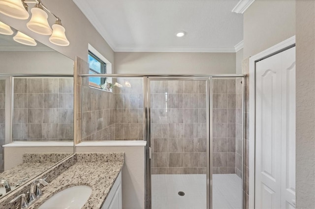 bathroom with ornamental molding, a shower with door, and vanity