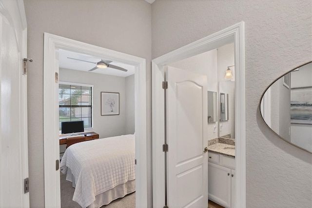 bedroom featuring ceiling fan and ensuite bathroom