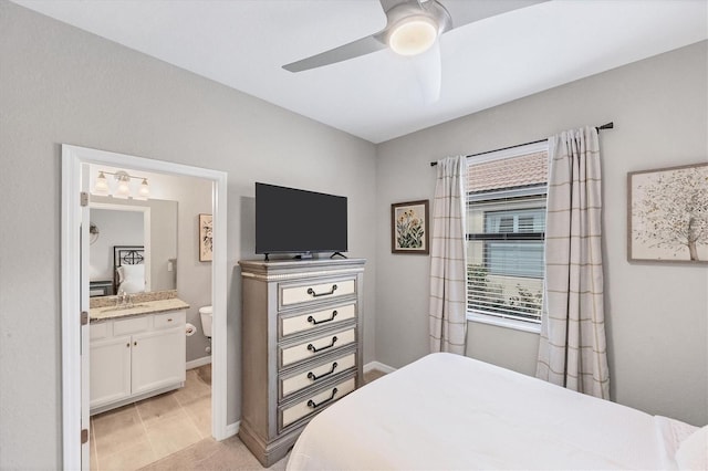 bedroom featuring ceiling fan, sink, and connected bathroom