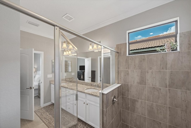 bathroom with an enclosed shower, vanity, tile patterned flooring, and crown molding