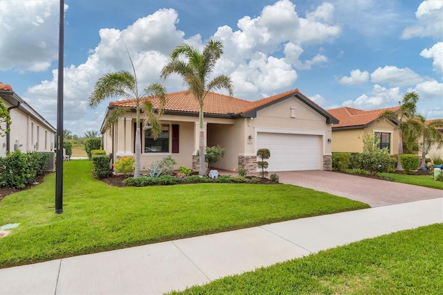 mediterranean / spanish home featuring a front yard and a garage